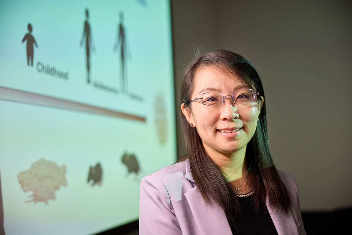 Yin Cao stands in front of early-onset colorectal cancer presentation slide