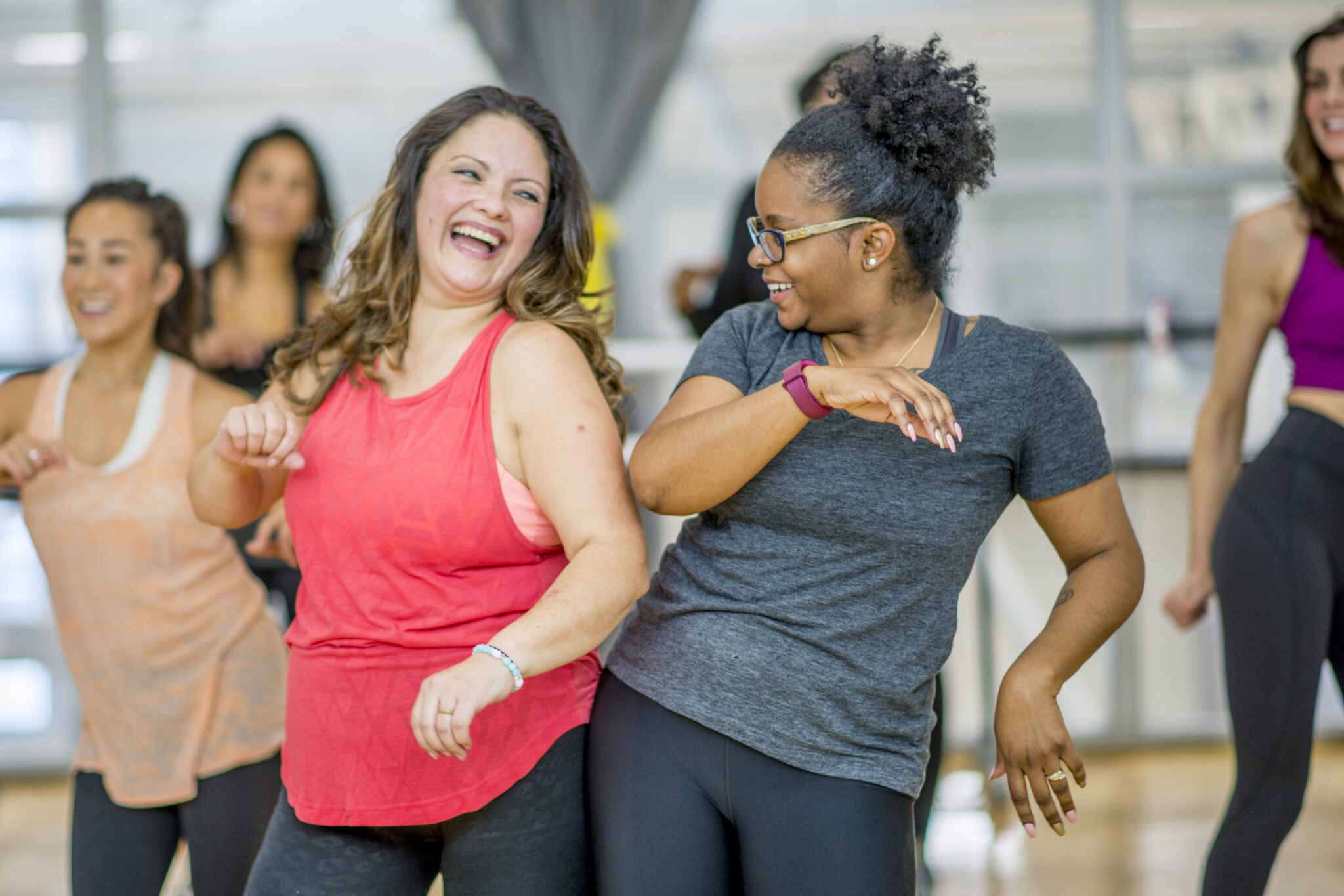 women in motion at a dance laugh together