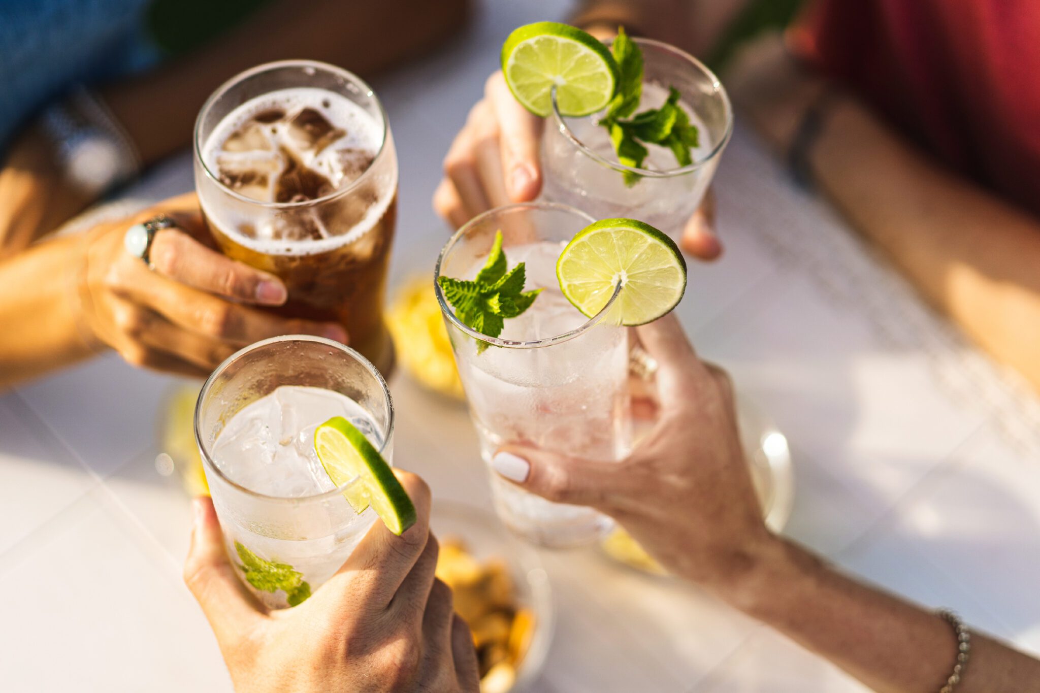 Group Of People Celebrating Toasting With Cocktails Cropped Detail With Focus On Hands Lifestyle Concept Of Drinks And Alcohol