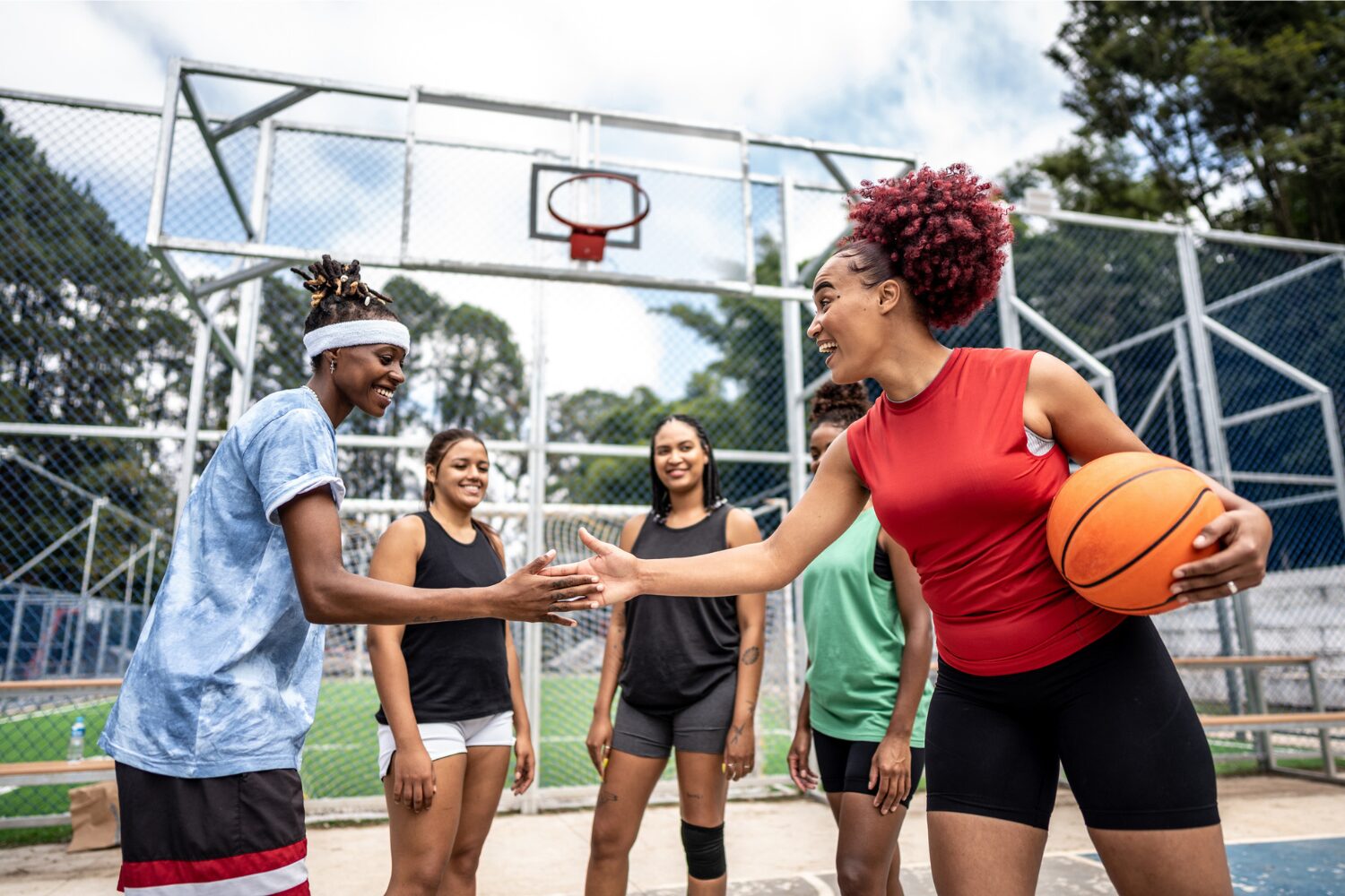 A group of people playing basketball