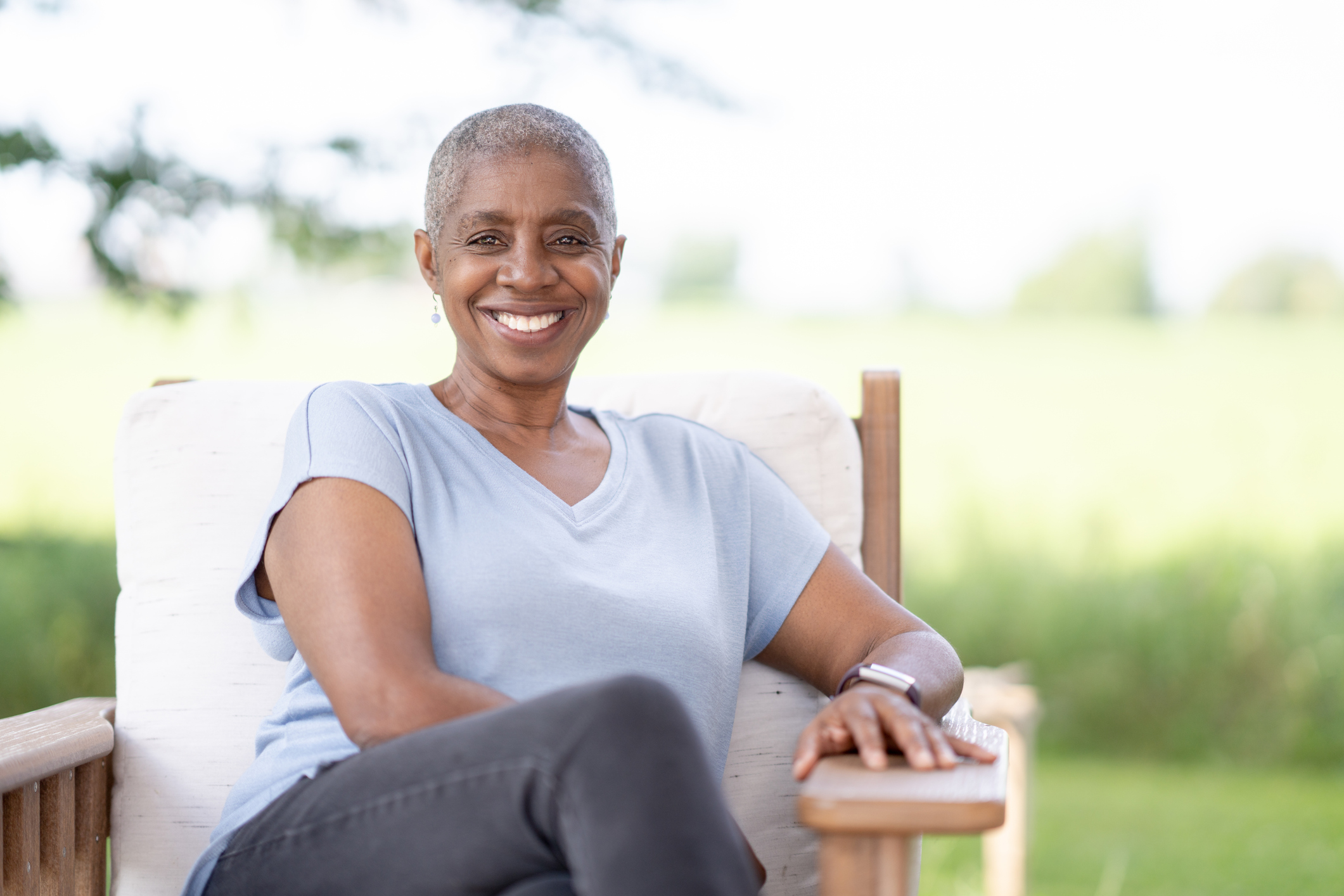 Portrait of a smiling woman sitting outside