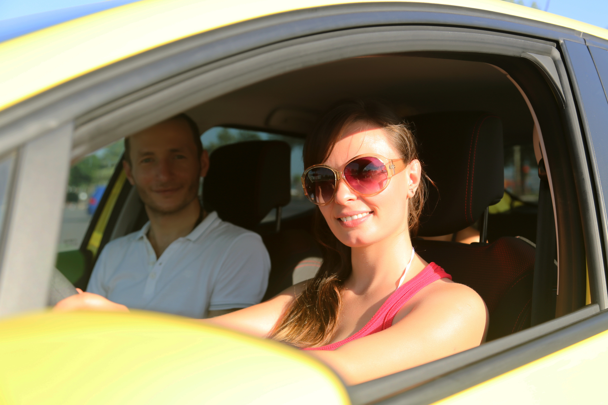 A couple in their car on a sunny day